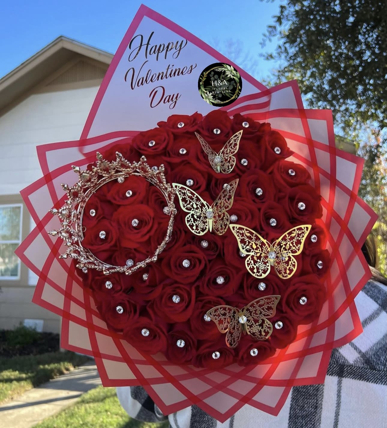 Red rose bouquet with rhinestones, butterfly picks, and a Valentine's Day topper