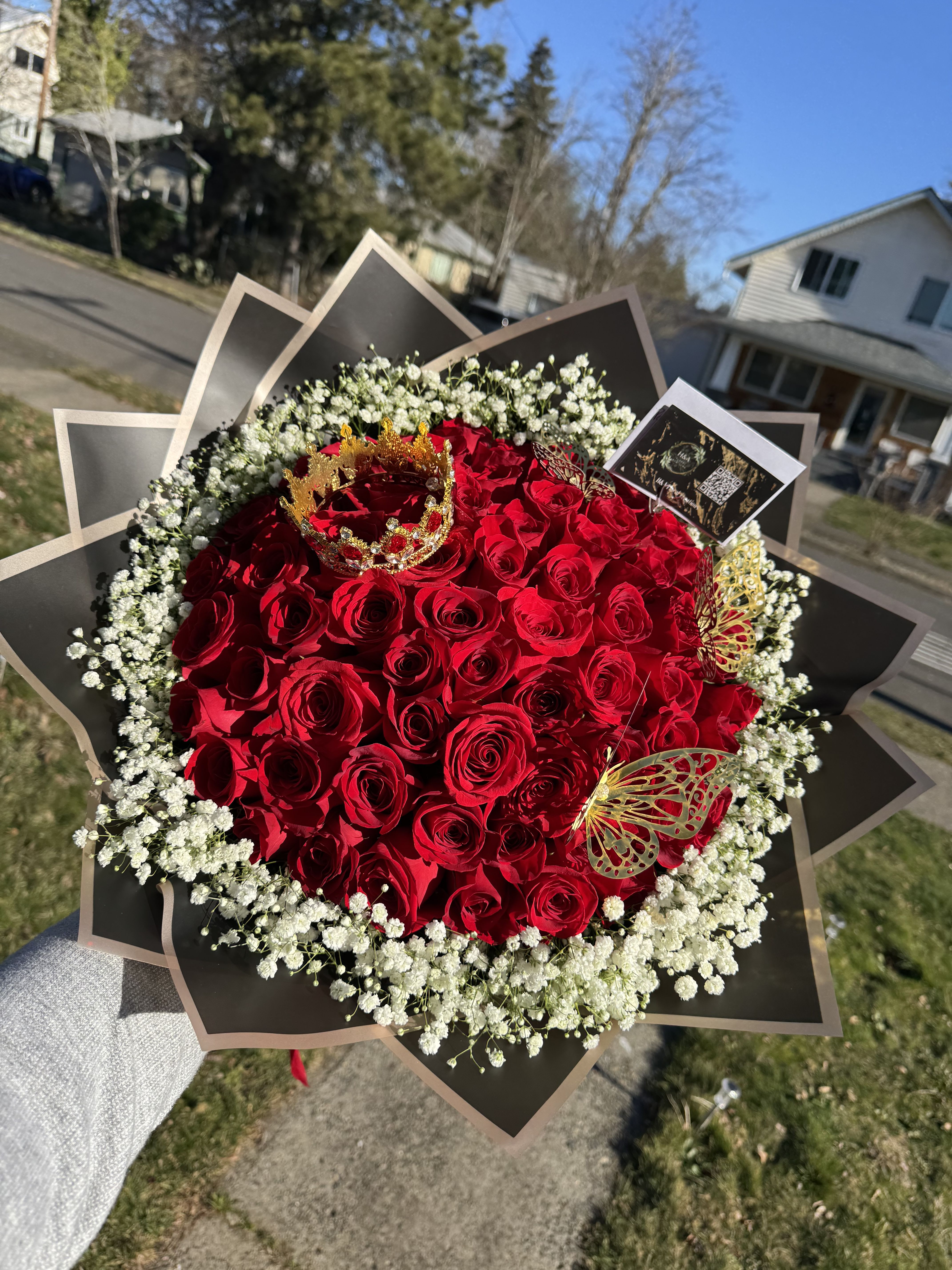 Large bouquet of red roses with white baby's breath and gold butterfly accents