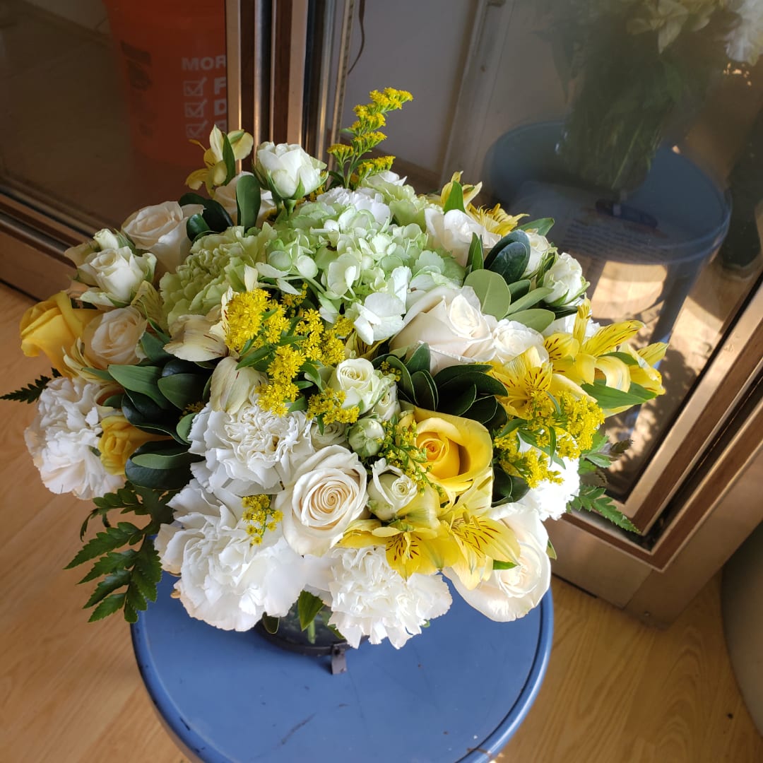 Wedding bouquet of white and yellow flowers with green foliage