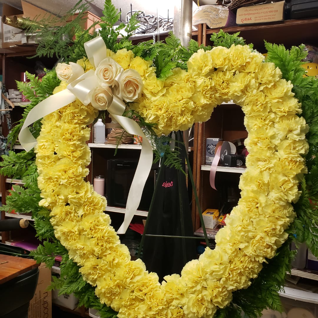 Yellow carnation heart wreath with cream roses and ribbon