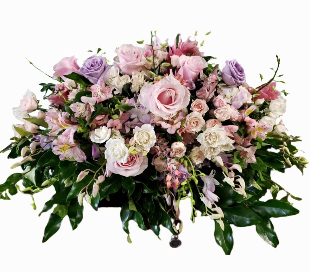 Pink and lavender floral casket spray with roses and alstroemeria