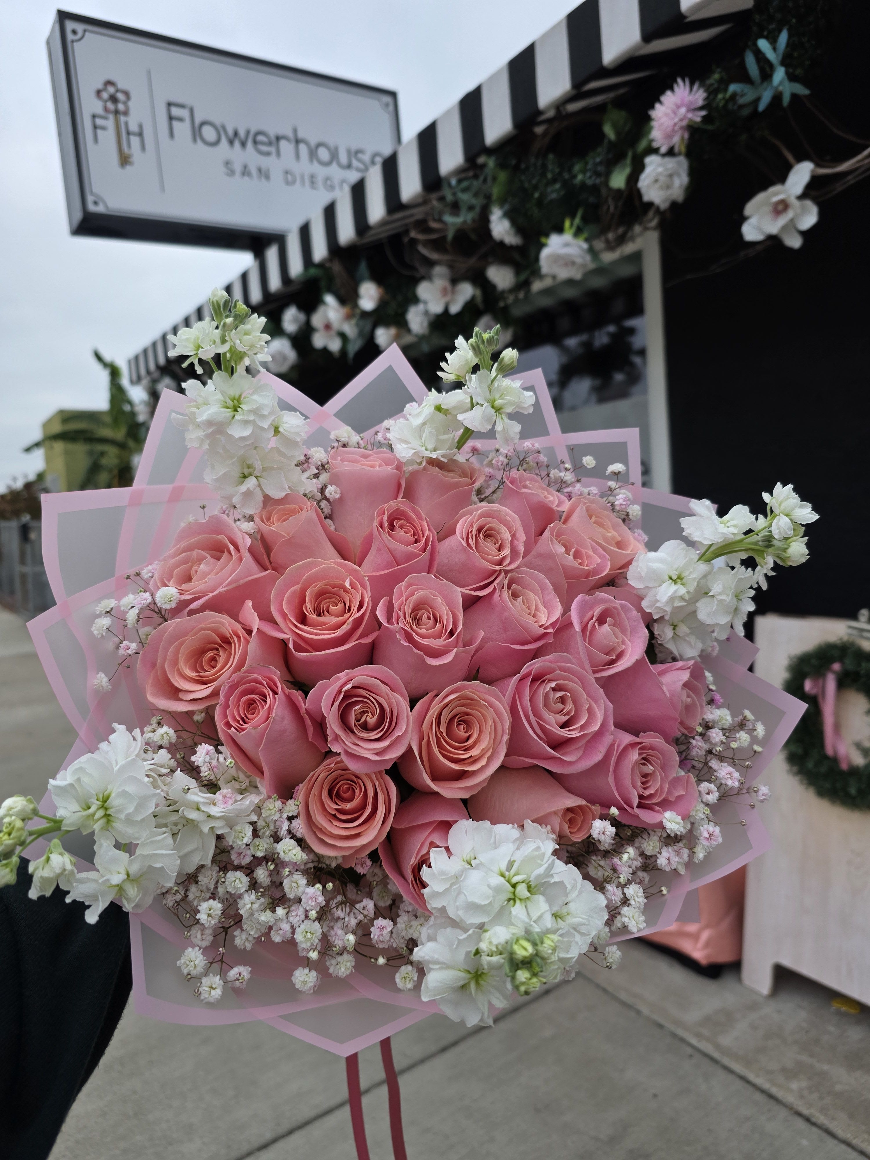 Sweetest Hermosa Bouquet  - A dense, rounded cluster of pink roses makes an immediate romantic impression-this Sweetest Hermosa bouquet is a birthday or Love and Romance bouquet that reads as tender, celebratory, and utterly feminine. Soft white filler blooms and airy accents weave through the pink to add delicate contrast, while pink translucent wrapping paper and a matching pink ribbon finish the presentation with a polished, gift-ready look. It's the kind of bouquet that will make the person you're thinking of feel genuinely seen and adored.  Carefully hand-tied for a compact, heart-like silhouette, this arrangement highlights pink roses with white filler flowers for a soft pink-and-white palette perfect for spring occasions, Mother's Day, or a romantic anniversary. The bouquet comes wrapped in pink paper wrap with decorative ribbon and layered pink wrapping paper for a refined unboxing moment. Flowerhouse San Diego delivers this charming arrangement across National City, CA-an easy, beautiful way to mark birthdays, express love, or send a sunny spring surprise.