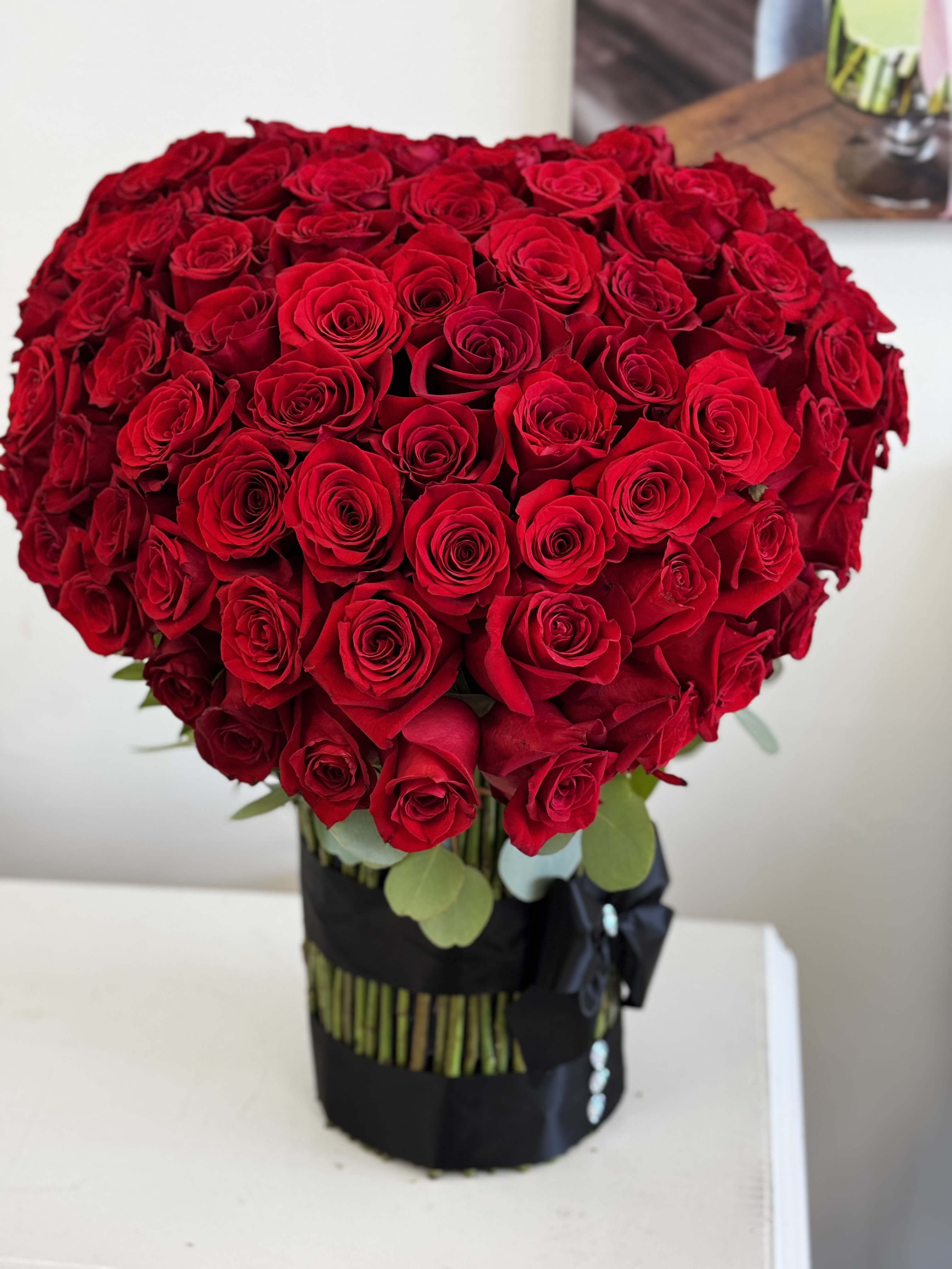 Large bouquet of red roses in a black wrap