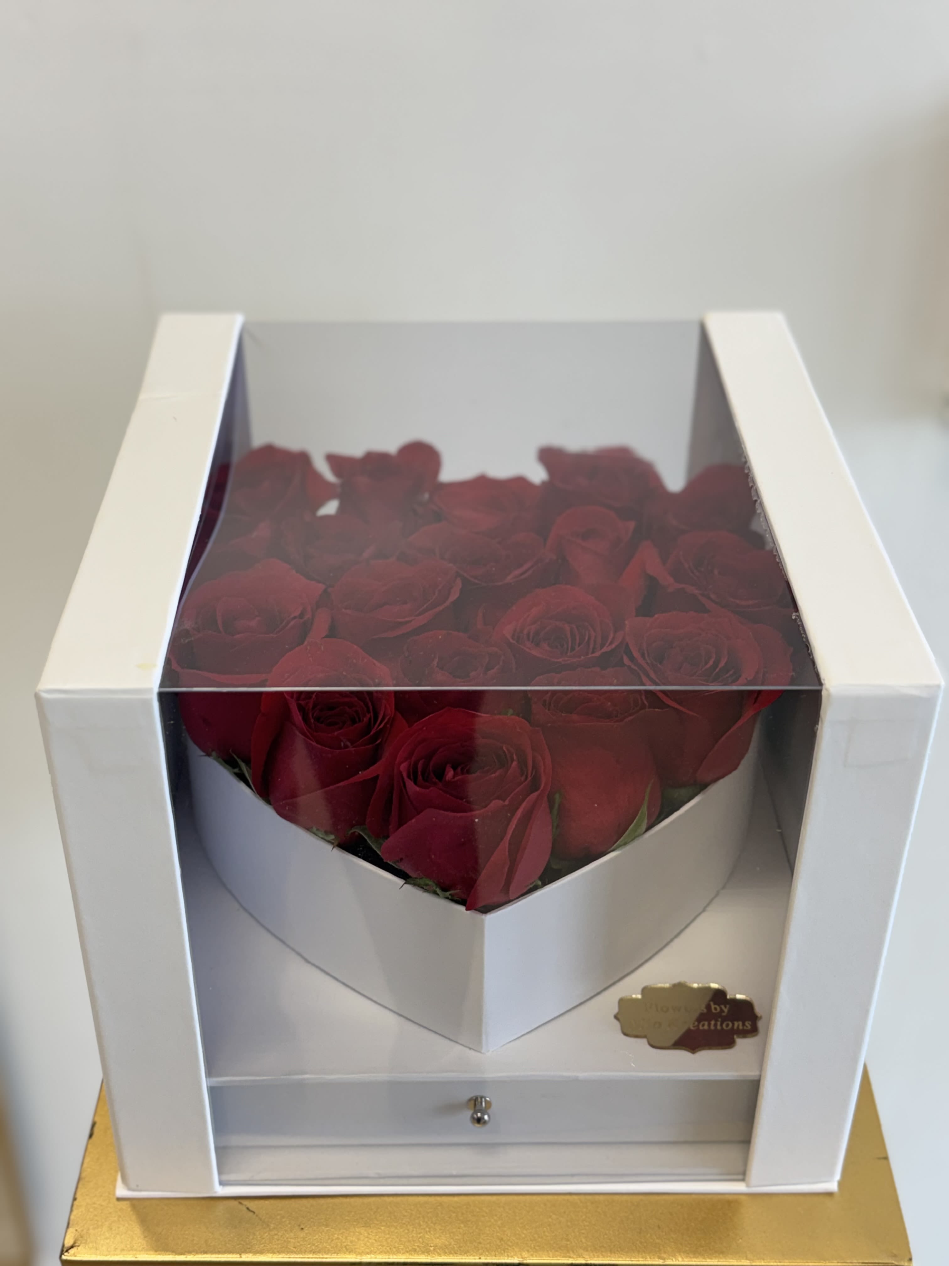 Boxed arrangement of red roses in a white gift box