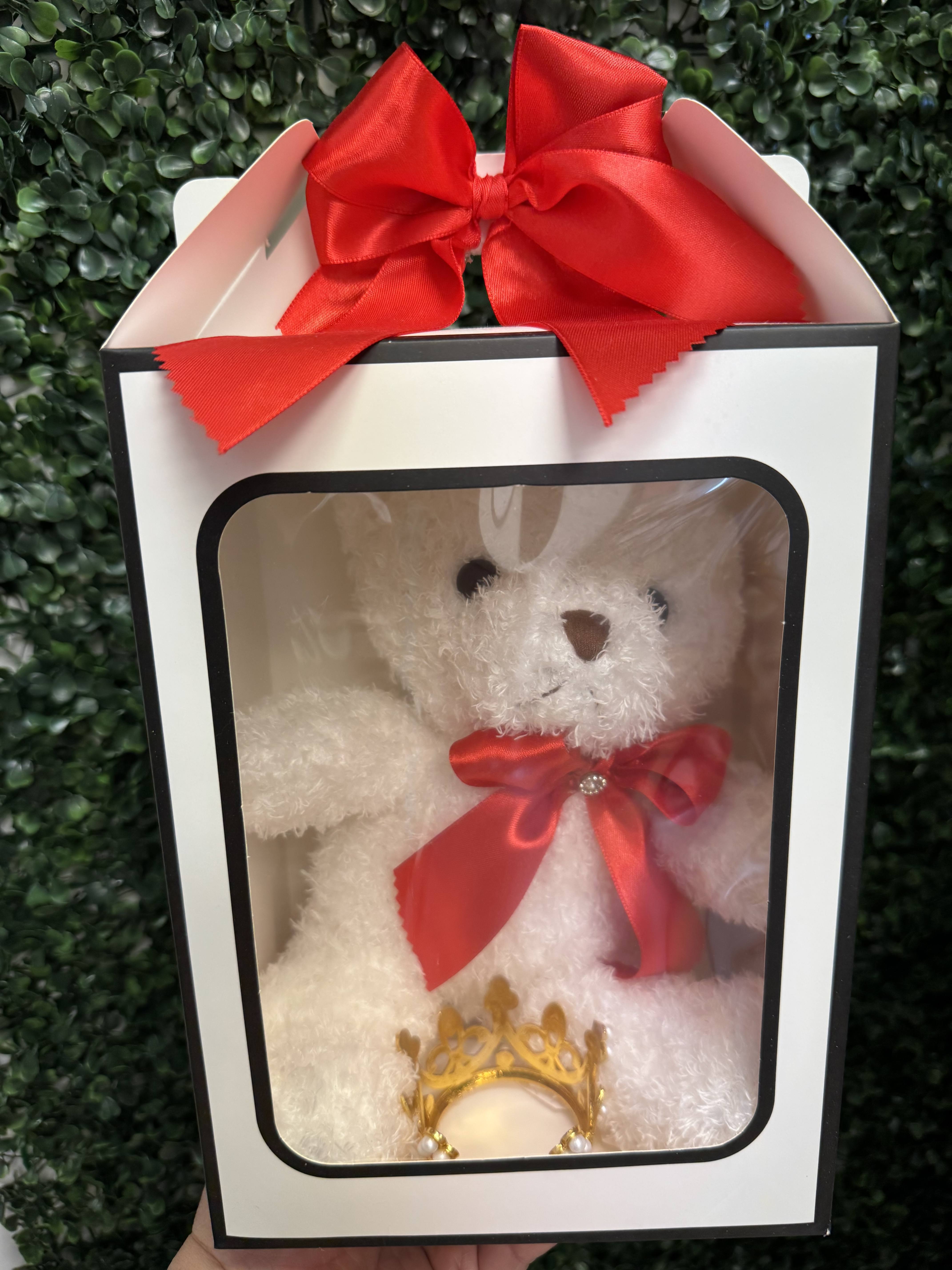 White teddy bear in a gift box with a red bow