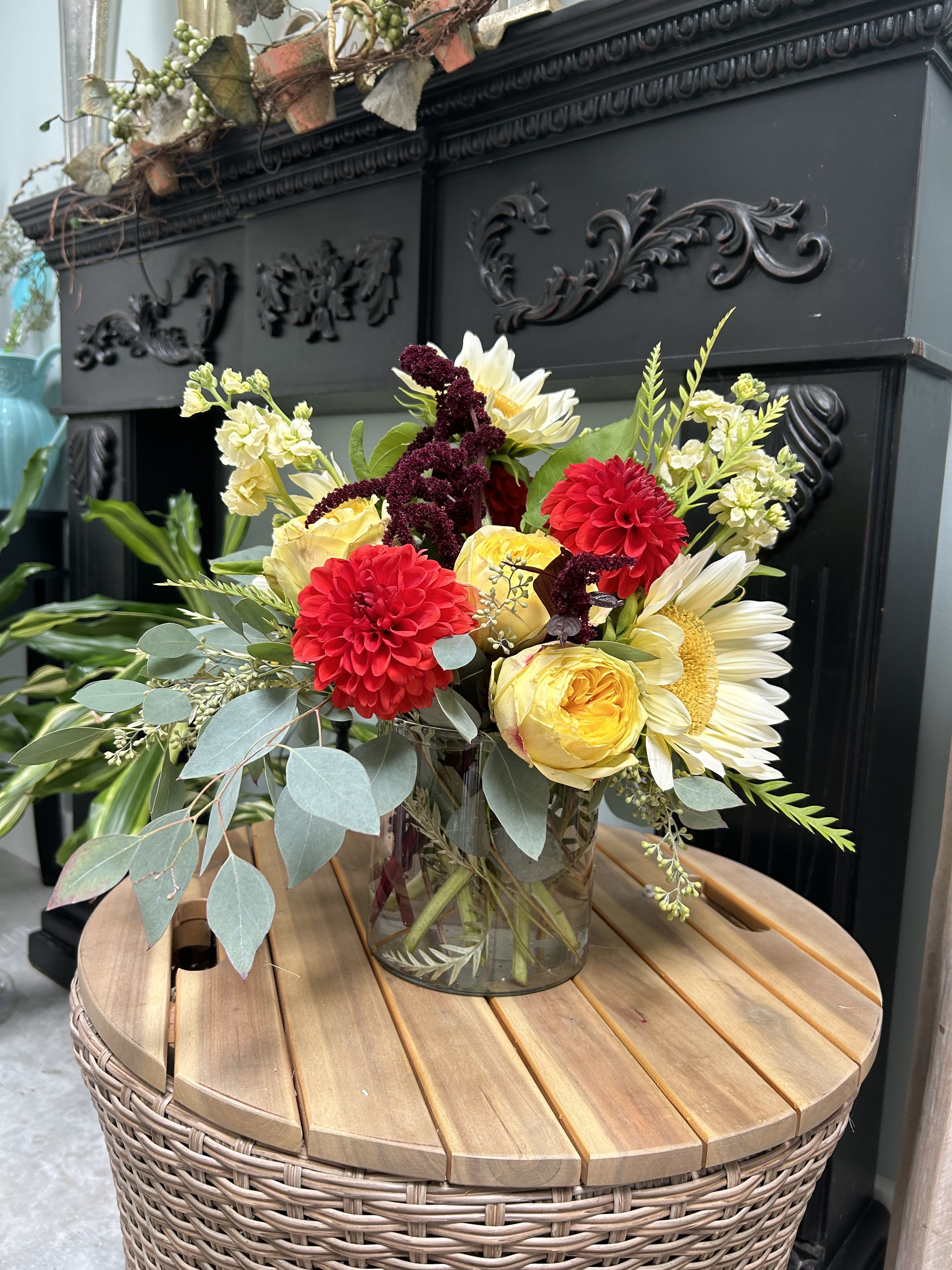 Bouquet of red, yellow, and white flowers in a glass vase