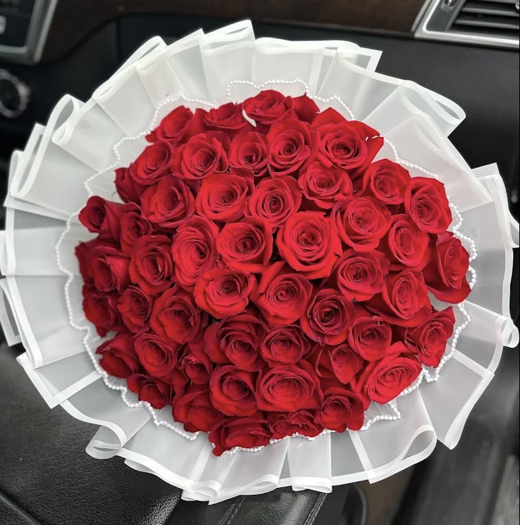 Bouquet of red roses wrapped in white paper