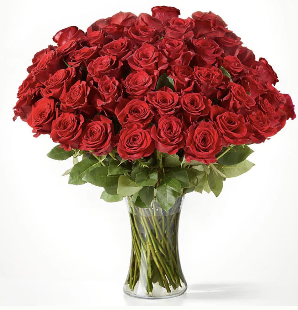50 Long Stem Red Roses  - Fifty long red roses arranged together, showcasing their vibrant and elegant appearance.