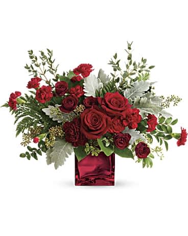 Rich In Love Bouquet by Teleflora - When you truly want to take their breath away, send this mesmerizing rose bouquet. Its artistic, organic design, luxurious blooms, and shimmering cube vase set it apart from the rest! This dramatic bouquet features red roses, dark red spray roses, maroon carnations, red miniature carnations, dusty miller, leatherleaf fern, huckleberry, seeded eucalyptus, lemon leaf, and parvifolia eucalyptus. Delivered in Teleflora's Red Mirrored Cube. Orientation: One-Sided 