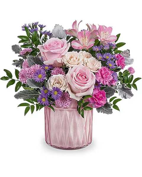 Pink and purple mixed bouquet in a pink glass vase