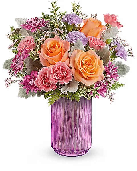 Bouquet of orange and pink roses in a purple glass vase