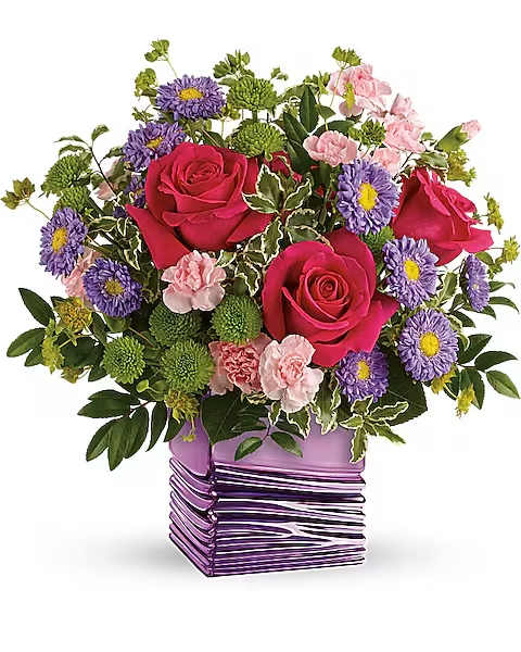 Bouquet of pink roses, purple daisies, and green pompons in a purple vase