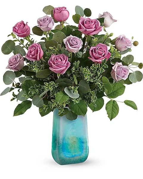 Pink and lavender roses in a blue glass vase