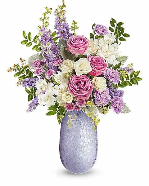 Pink and white roses with purple flowers in a lavender vase