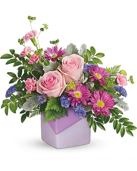 Pink roses and purple daisies in a lavender vase