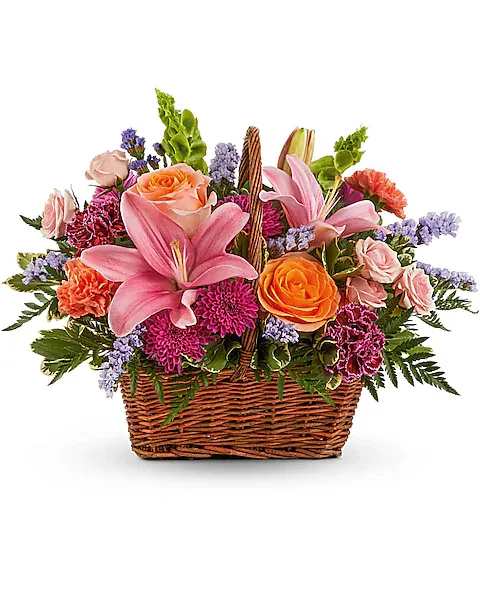Basket arrangement with pink lilies, roses, and purple flowers