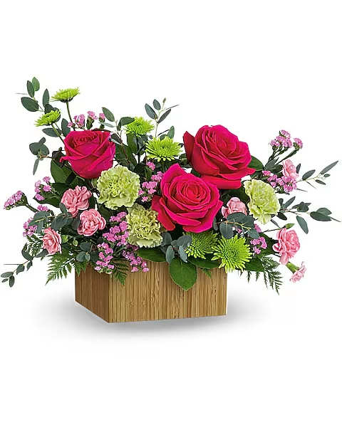 Pink roses and carnations in a wooden box