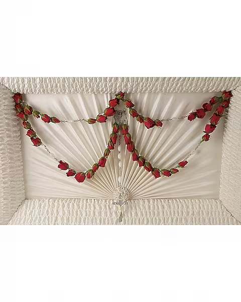 White casket spray with red rose garlands
