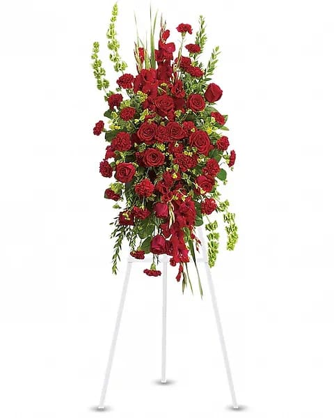 Tall red floral standing spray on a white easel