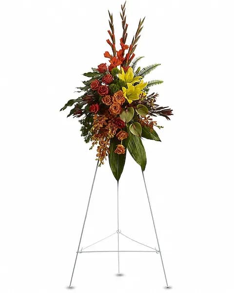 Tall floral spray on a metal easel with red, orange, and yellow flowers