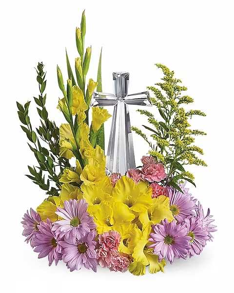 Yellow gladiolus and purple daisies arranged around a silver cross
