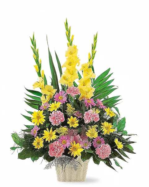 Tall mixed flower arrangement in a textured vase with yellow spikes and pink blooms