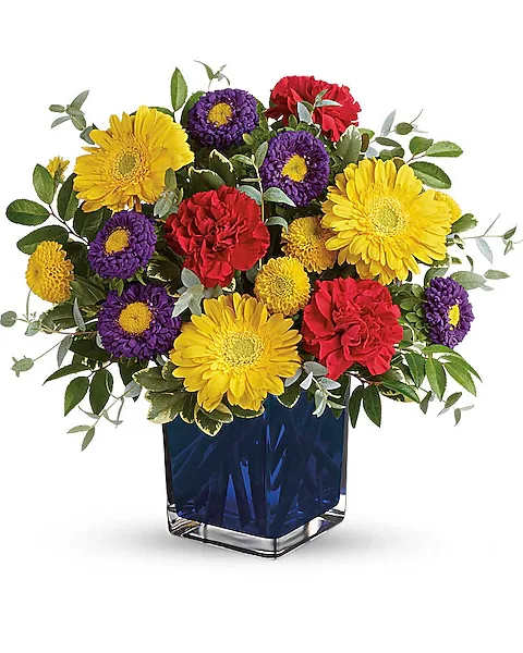 Colorful bouquet of yellow, purple, and red flowers in a blue glass vase