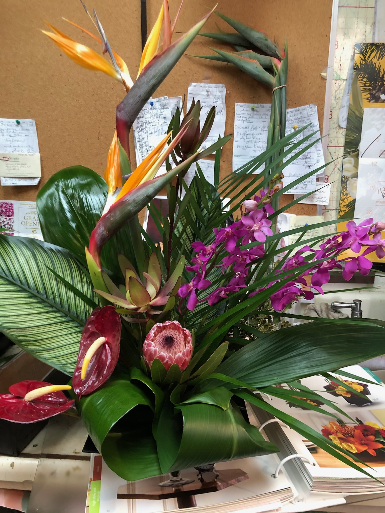 Tropical arrangement with bird of paradise, orchids, and anthuriums