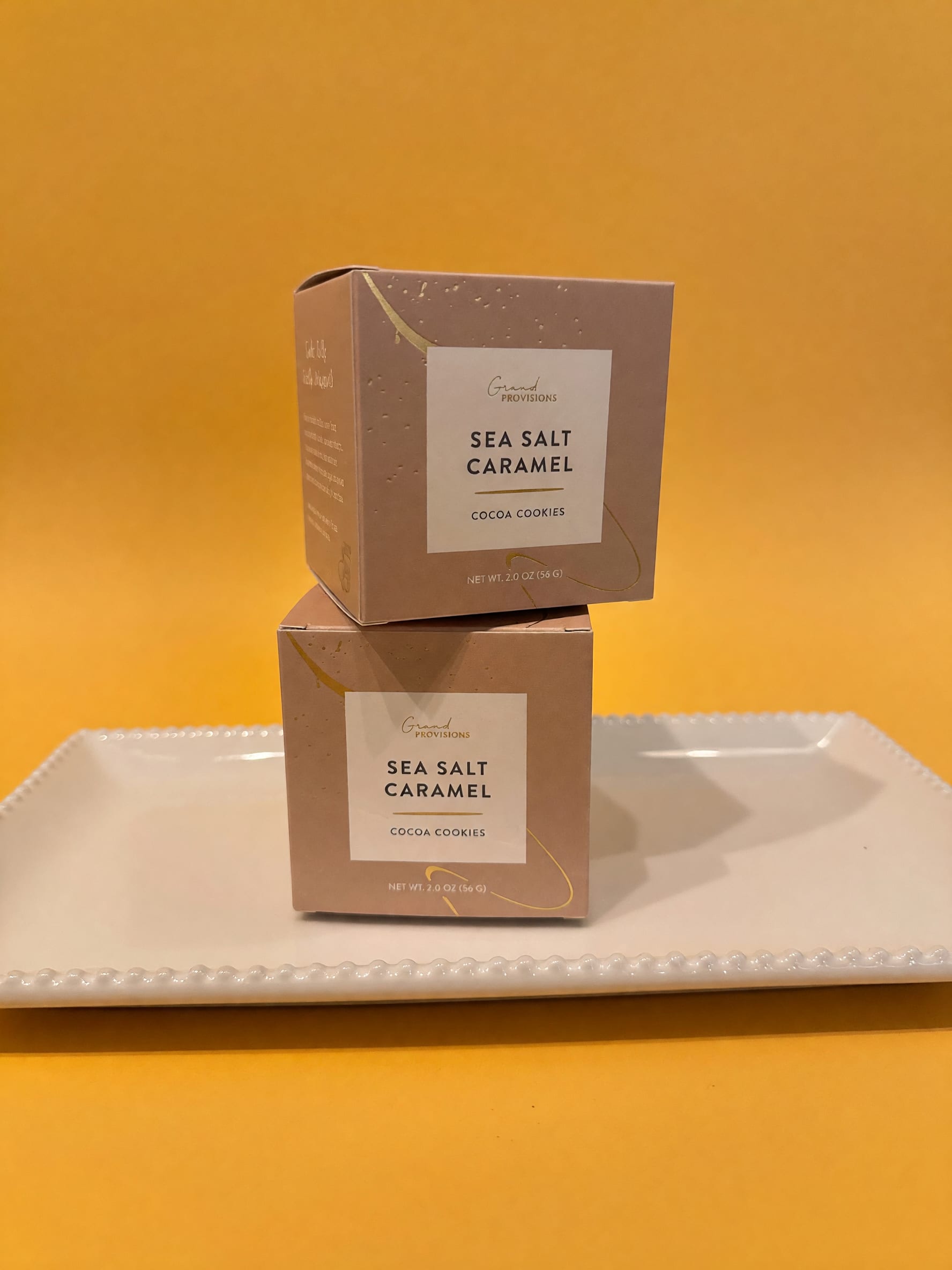 Two boxes of sea salt caramel cocoa cookies on a tray
