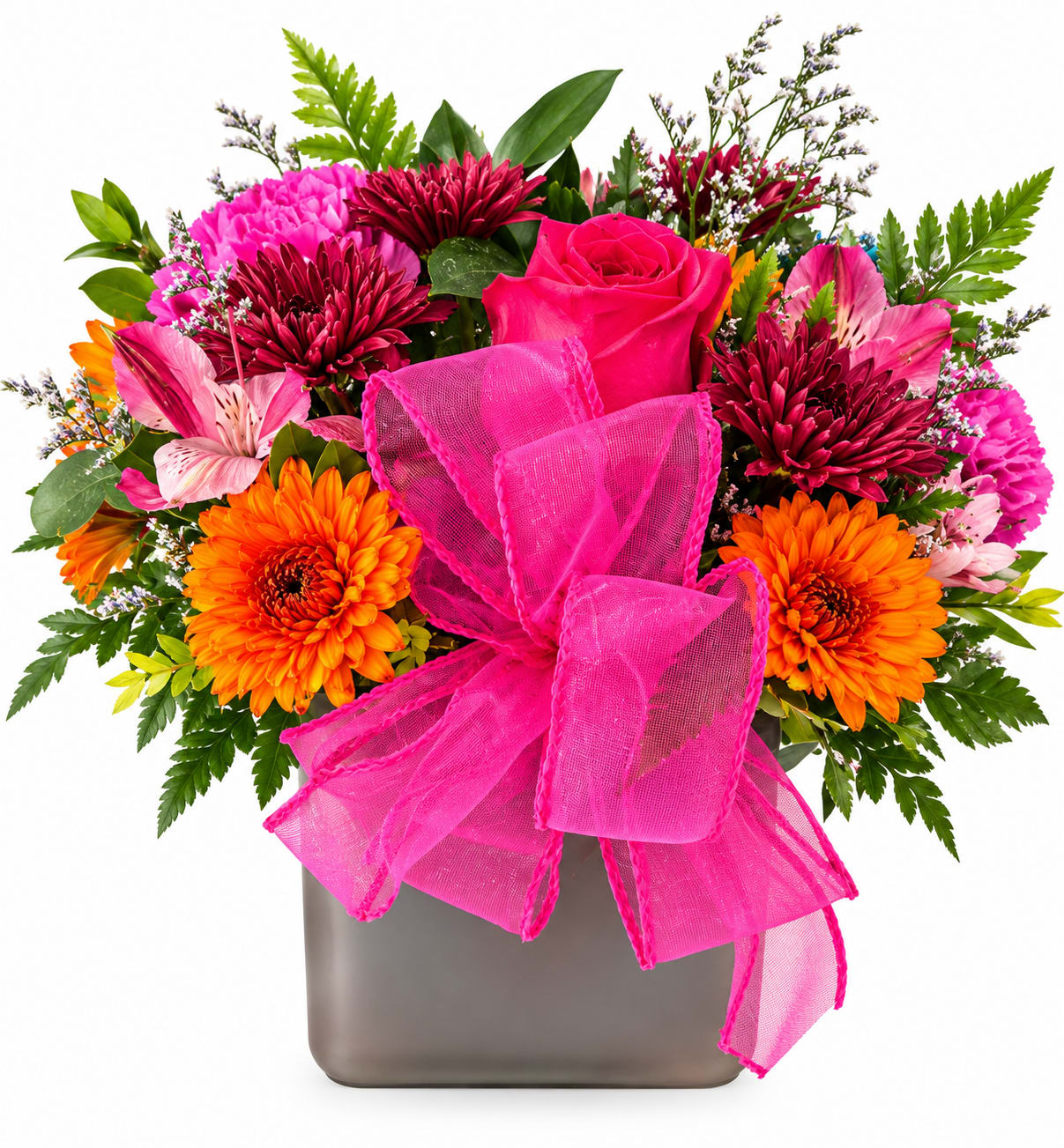 Bright mixed bouquet with pink roses, orange daisies, and a hot pink bow in a square vase