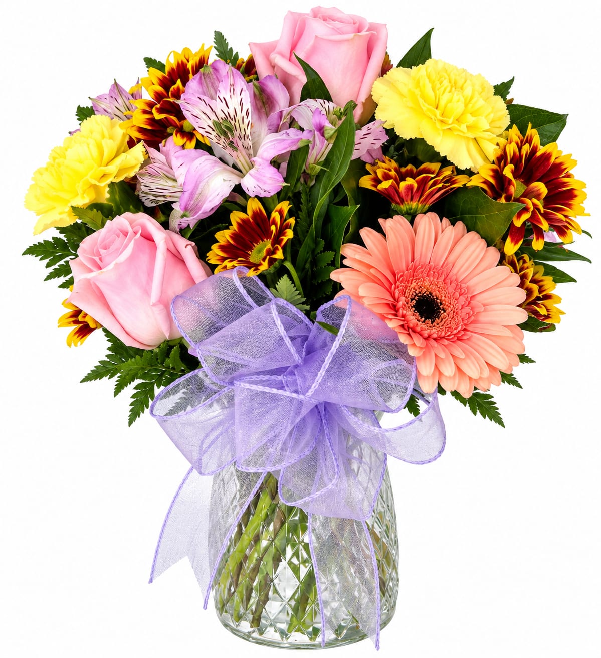 Mixed bouquet of pink roses, gerbera daisies, and carnations in a glass vase with a purple bow