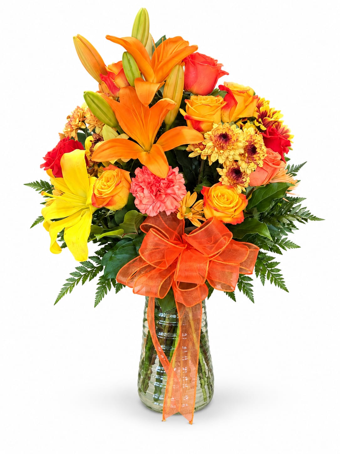 Bright mixed bouquet with lilies, roses, and chrysanthemums in a glass vase