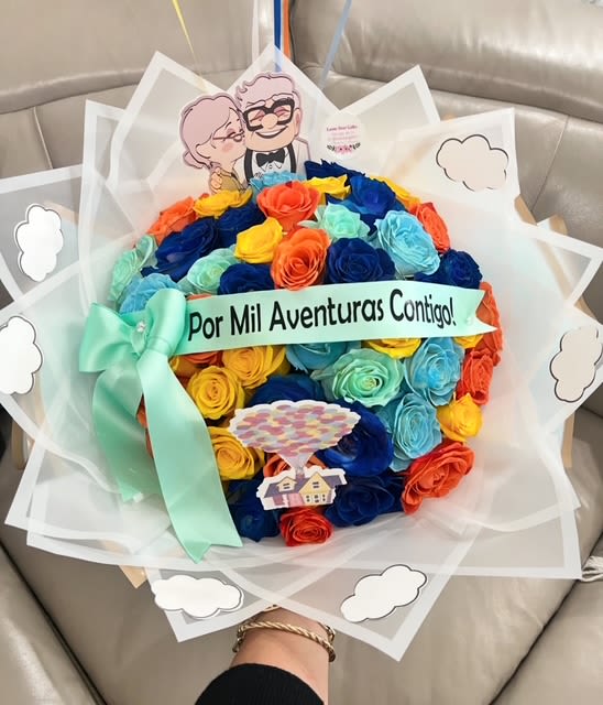 Colorful rose bouquet with a ribbon and a cartoon topper