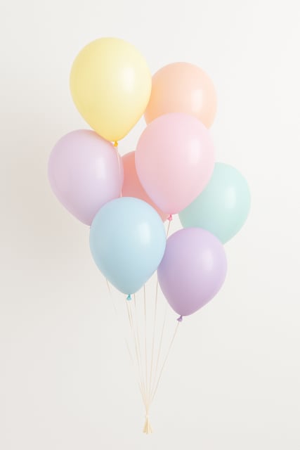Cluster of pastel balloons in yellow, pink, blue, and lavender