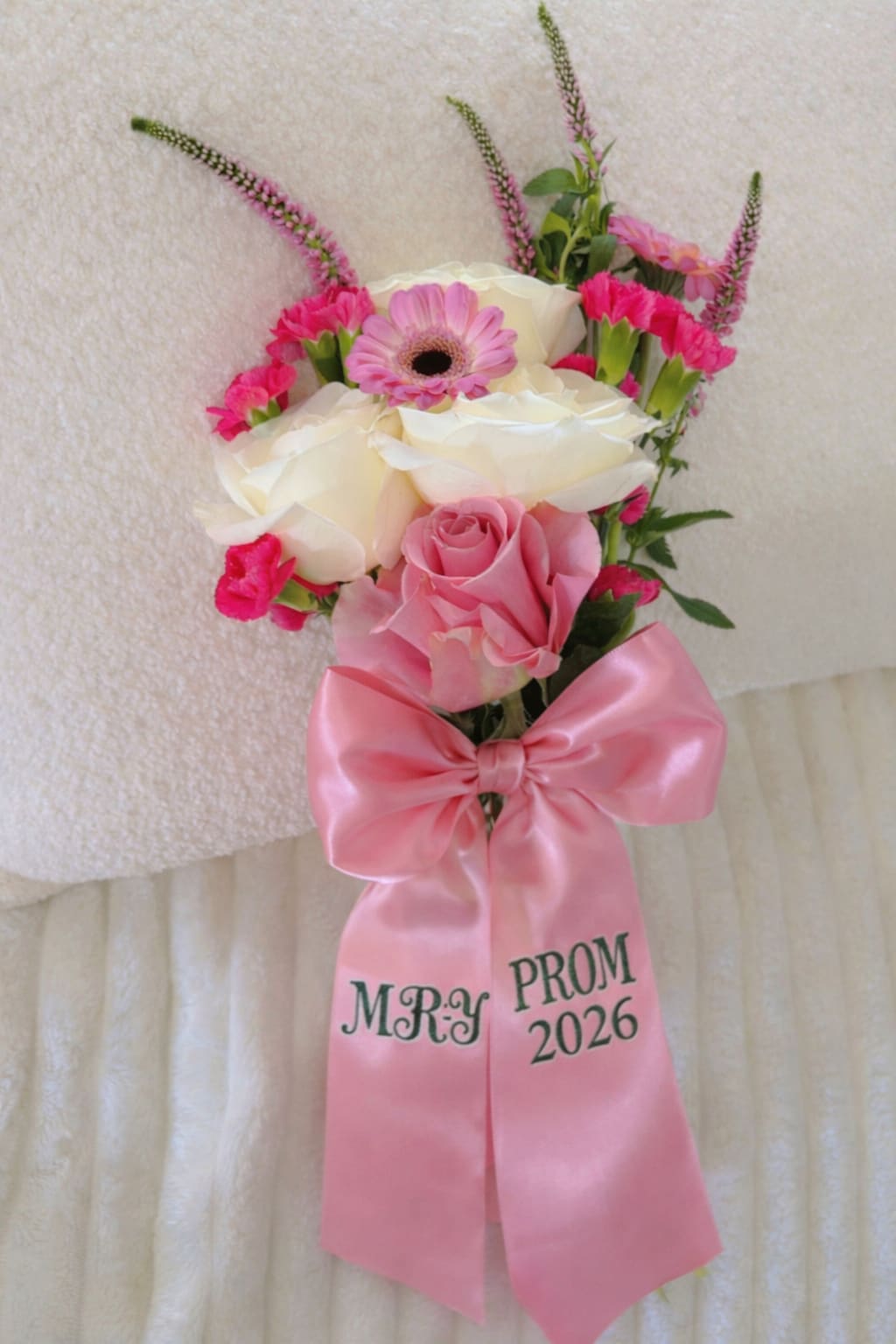 Pink and white prom corsage with roses, gerbera daisy, and a satin bow
