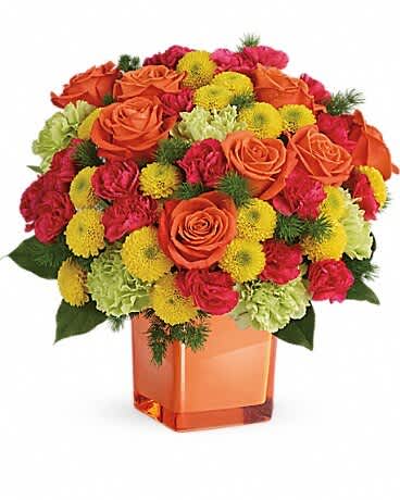 Orange roses and yellow pompons in a square glass vase