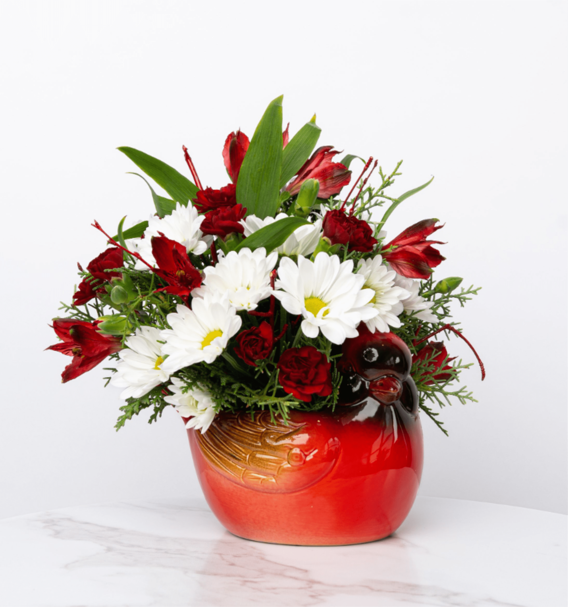 Our Holiday Collection: Cheerful Cardinal - Looking to spread winter joy or a peaceful reminder? Our Holiday Collection's Cheerful Cardinal arrangement is designed with rich hues in a charming ceramic cardinal vase right here in Valparaiso to express hope, warmth, and heartfelt sentiment.  At Schultz Floral, each arrangement is one of a kind and styled just for your order in our Valparaiso Shop. Because we always use the freshest blooms, your final arrangement may not look exactly as pictured due to daily availability.
