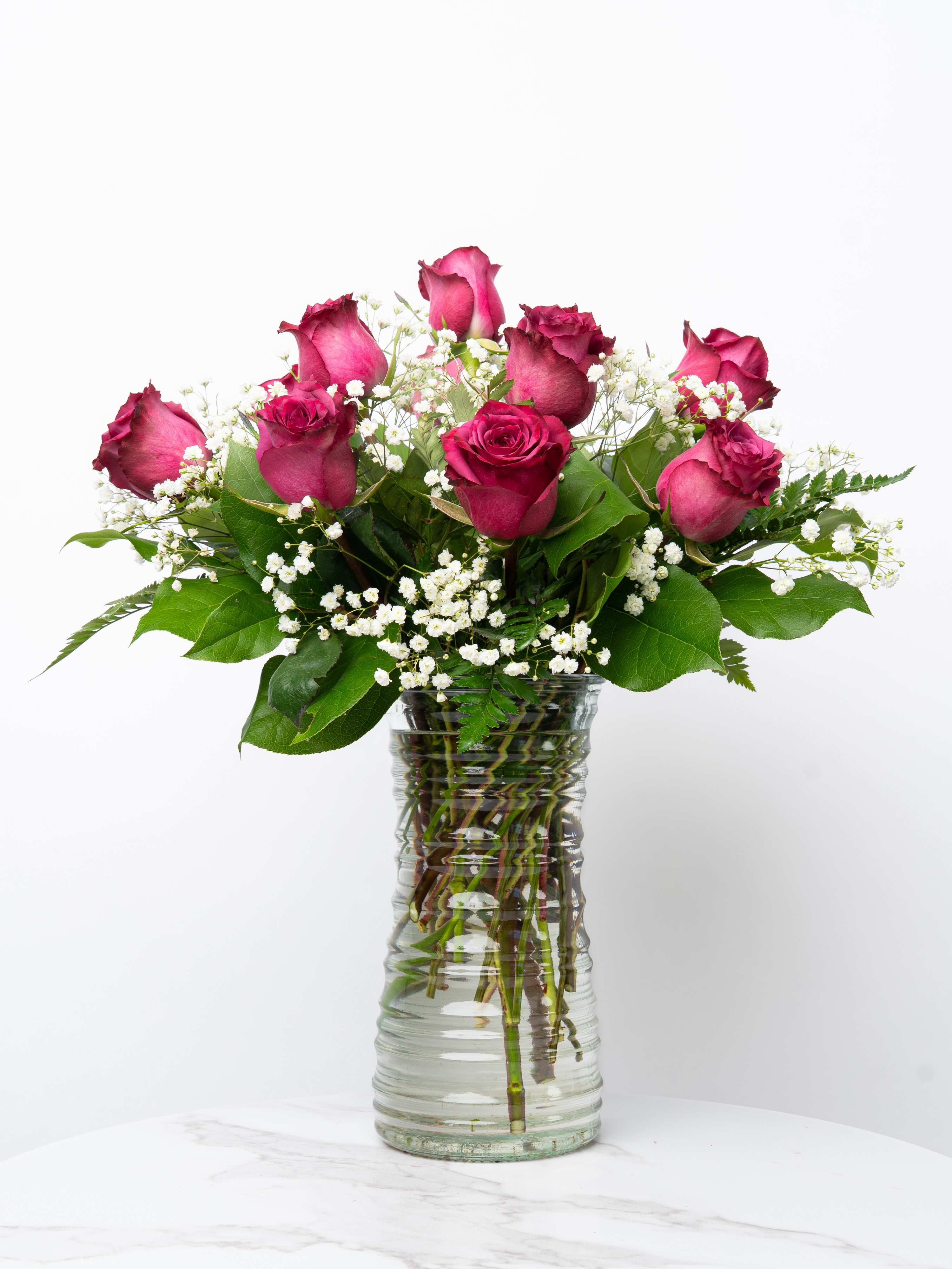 Pink roses and baby's breath in a clear glass vase