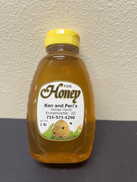 Bottle of pure honey with a yellow cap and labeled front