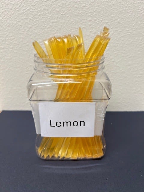 Clear jar filled with yellow lemon-flavored straws