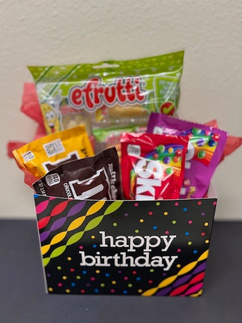 Birthday gift bag filled with assorted candy packages