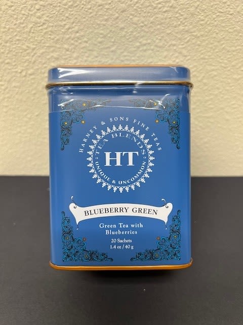 Blue tin of blueberry green tea on a table