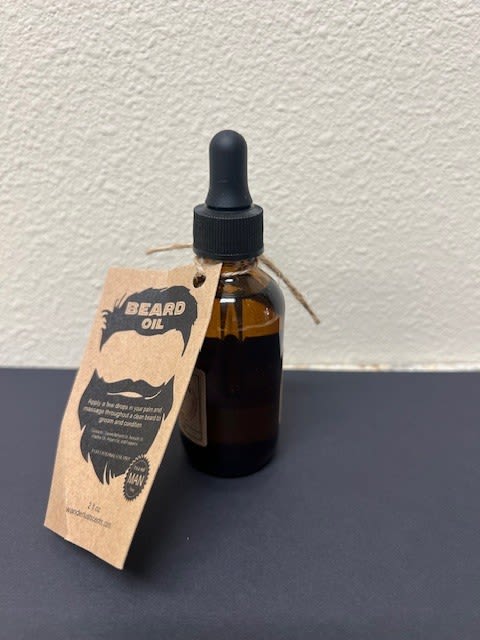 Amber dropper bottle labeled beard oil with a hanging tag
