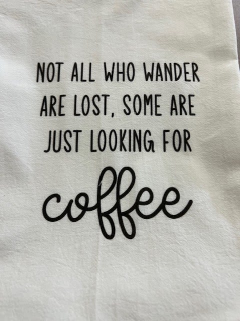 White fabric with black quote text about coffee