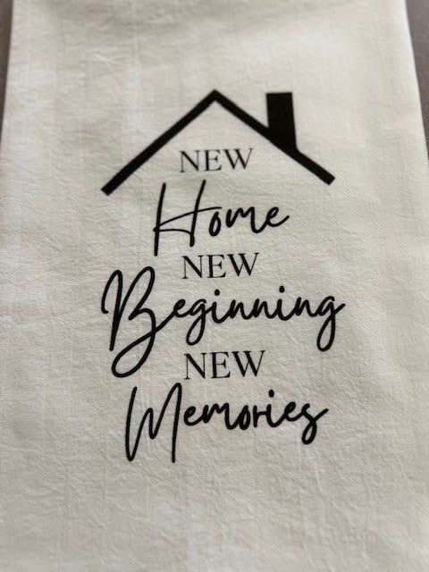 White fabric with a house graphic and the words New Home, New Beginning, New Memories