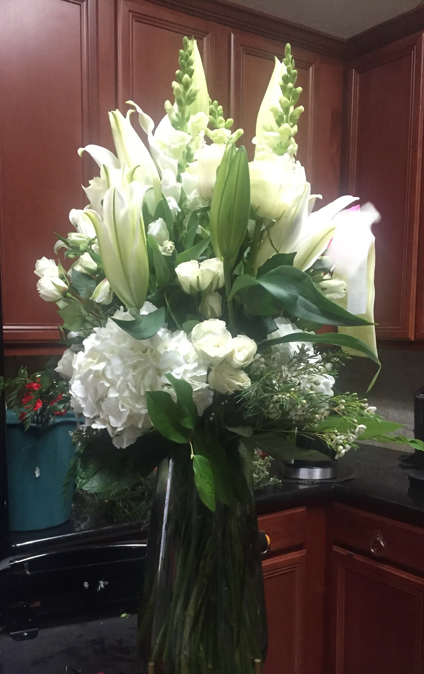 Shimmering white - Breathtakingly beautiful flower arrangement features an all white bouquet or=f roses, lilies and more