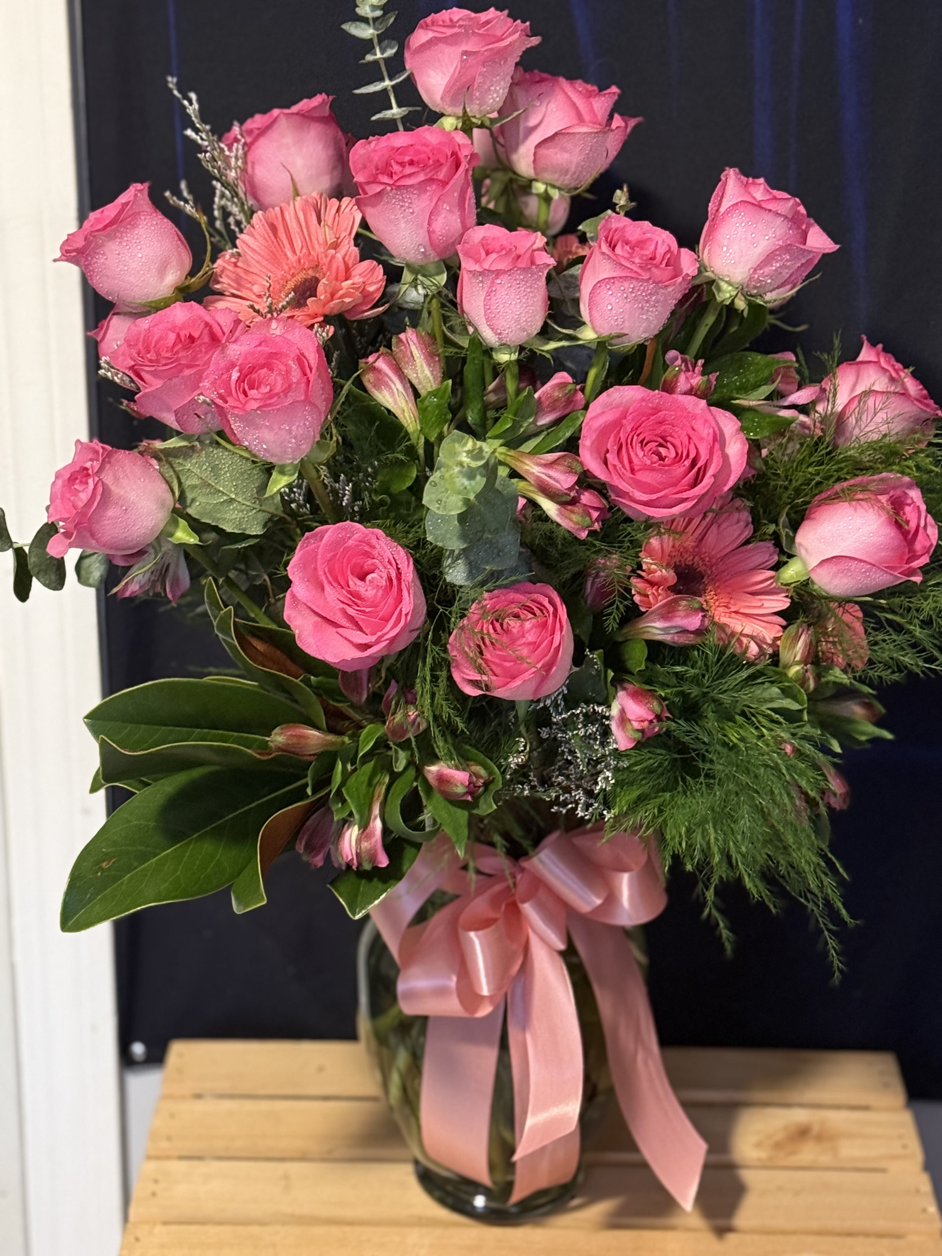 Pink rose bouquet with gerbera daisies in a glass vase