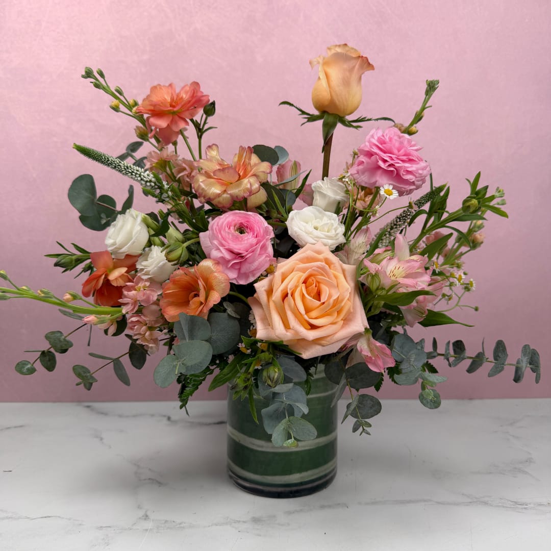 Soft &amp; Sentimental Cylinder - Blush, ivory, and soft pastel tones create a warm and comforting arrangement filled with softness and texture. Each design is thoughtfully created using the freshest flowers available, ensuring a beautiful and unique result every time.  Arranged in a taller cylinder vase, this style offers added height and presence, making it one of our most popular choices.  Available in three sizes. For a fuller, more eye-catching design, we recommend upgrading to Deluxe or Premium.