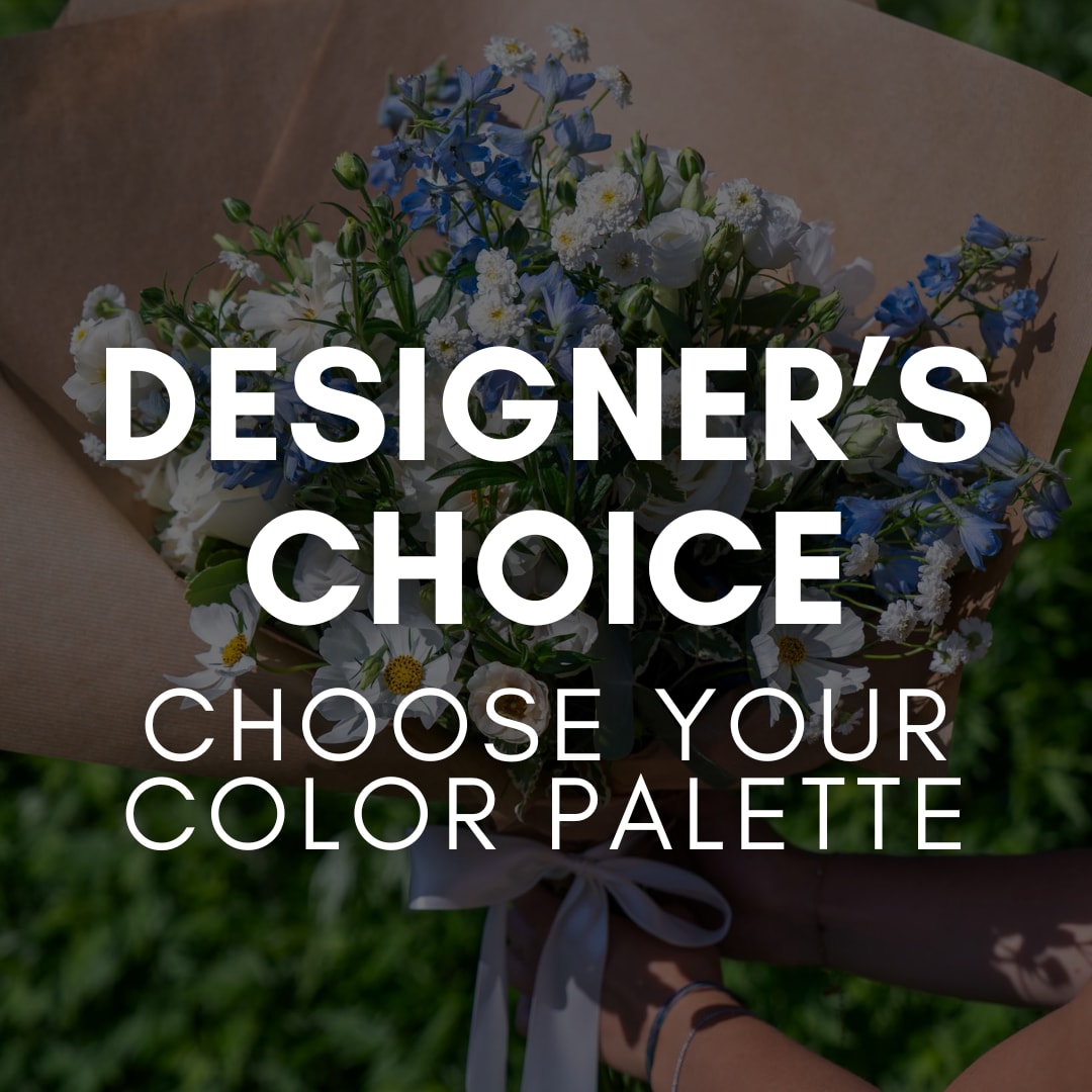 Handheld bouquet of blue and white flowers wrapped in brown paper