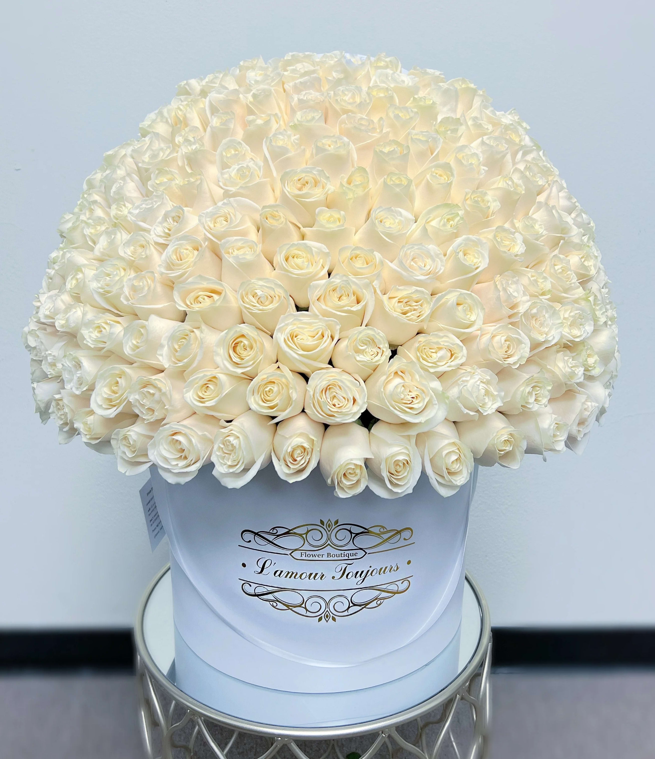 Large bouquet of white roses in a round white box
